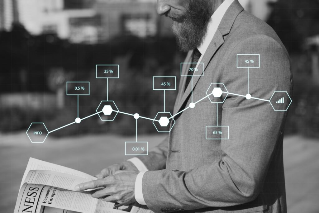 Business professional in suit reading newspaper with data visualization overlay showing percentages (0.5%, 35%, 45%, 70%, 45%, 65%), representing knowledge management statistics and inefficiencies in small and medium enterprises